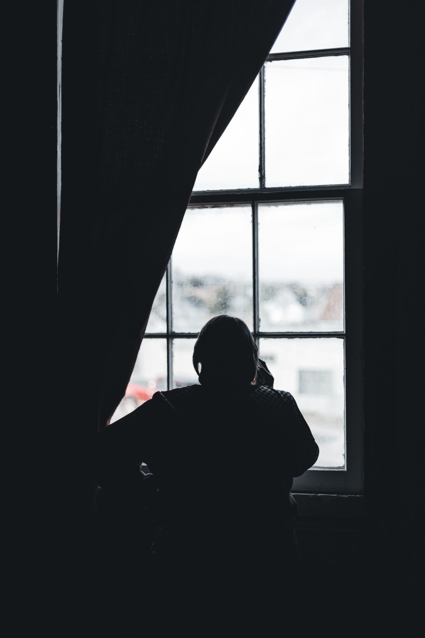 Older Adult Looking Out Window
